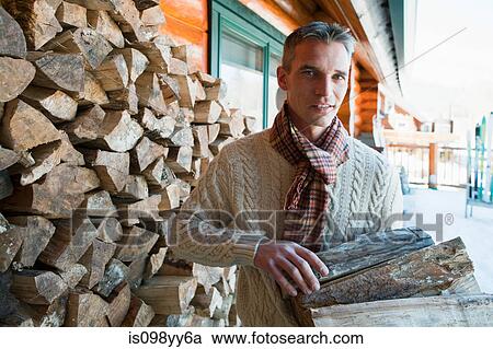 Man holding logs, portrait View Large Photo Image Stock Image - Man holding logs, portrait. Fotosearch