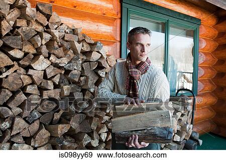 Man holding logs, portrait View Large Photo Image Stock Photo - Man holding logs, portrait. Fotosearch