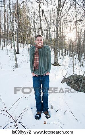 Man standing in snow, portrait View Large Photo Image Stock Image - Man standing in snow, portrait. Fotosearch