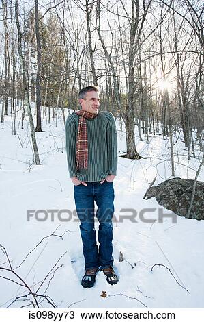 Man standing in snow, portrait View Large Photo Image Stock Image - Man standing in snow, portrait. Fotosearch