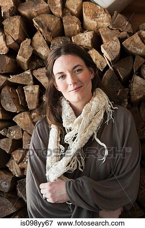 Woman in front of logs, portrait View Large Photo Image Stock Photo - Woman in front of logs, portrait. Fotosearch