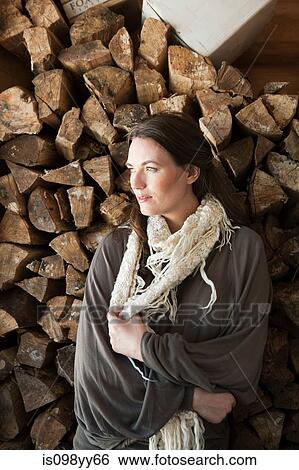 Woman in front of logs, portrait View Large Photo Image Stock Photograph - Woman in front of logs, portrait. Fotosearch
