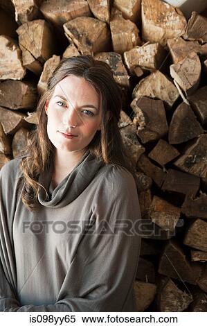 Woman in front of logs, portrait View Large Photo Image Stock Photography - Woman in front of logs, portrait. Fotosearch