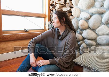 Woman sitting in log cabin, portrait View Large Photo Image Stock Image - Woman sitting in log cabin, portrait. Fotosearch