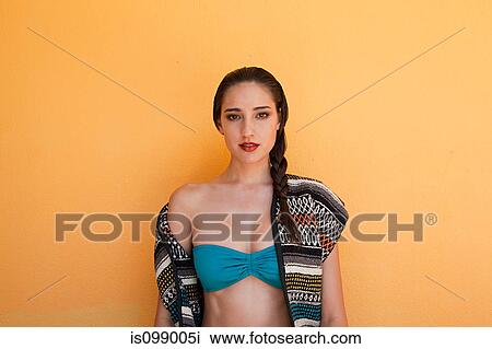 Woman against yellow wall View Large Photo Image Stock Image - Woman against yellow wall. Fotosearch