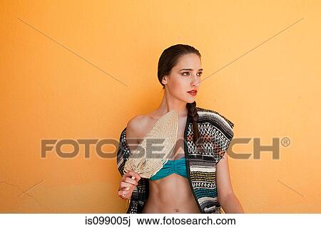 Woman against yellow wall View Large Photo Image Stock Image - Woman against yellow wall. Fotosearch