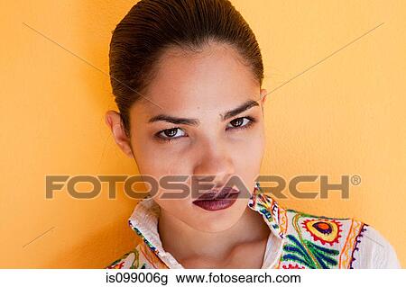 Woman against yellow wall View Large Photo Image Stock Image - Woman against yellow wall. Fotosearch