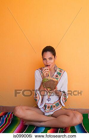 Stock Image - Woman drinking tropical fruit juice. Fotosearch