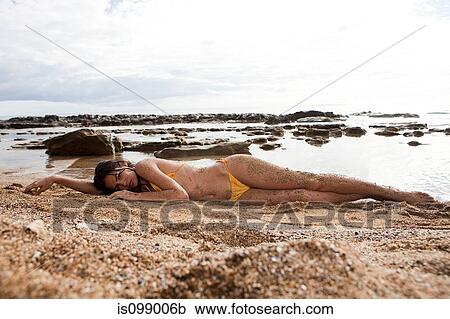 Woman lying on beach View Large Photo Image Stock Image - Woman lying on beach. Fotosearch
