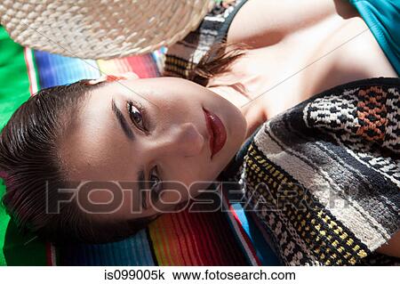 Woman lying on ethnic style blanket, close up View Large Photo Image Stock Image - Woman lying on ethnic style blanket, close up. Fotosearch