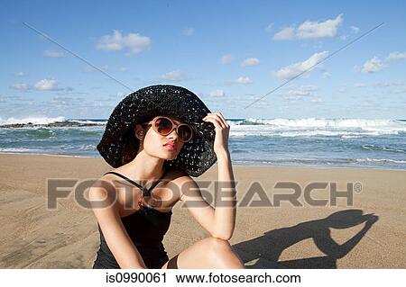 Woman on beach wearing sunglasses and sunhat View Large Photo Image Stock Image - Woman on beach wearing sunglasses and sunhat. Fotosearch