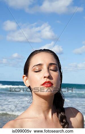 Woman on beach with eyes closed View Large Photo Image Stock Photo - Woman on beach with eyes closed. Fotosearch