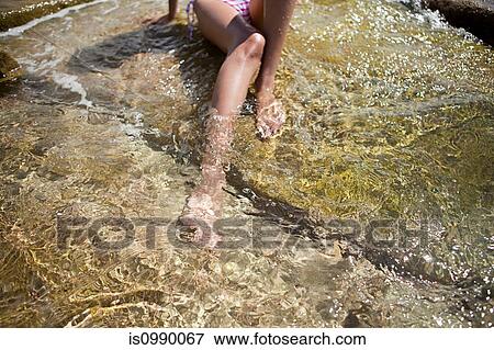 Woman paddling in shallow water View Large Photo Image Stock Photo - Woman paddling in shallow water. Fotosearch