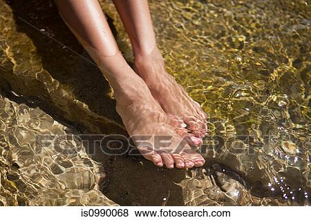 Woman paddling in shallow water View Large Photo Image Stock Photo - Woman paddling in shallow water. Fotosearch