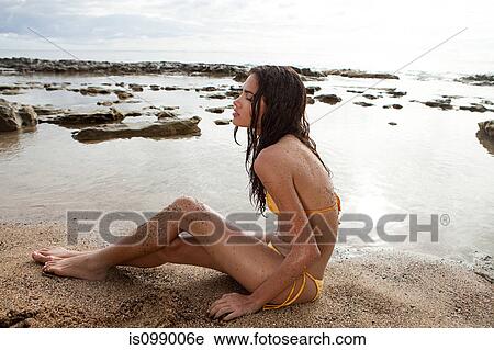 Woman sitting on beach View Large Photo Image Stock Image - Woman sitting on beach. Fotosearch
