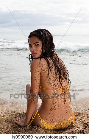 Woman sitting on beach View Large Photo Image Stock Photo - Woman sitting on beach. Fotosearch