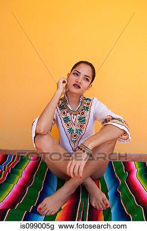 Woman sitting on ethnic style blanket View Large Photo Image Stock Image - Woman sitting on ethnic style blanket. Fotosearch