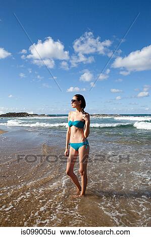 Woman standing at water's edge View Large Photo Image Stock Photograph - Woman standing at water's edge. Fotosearch