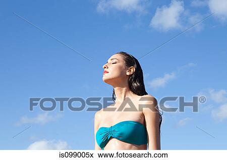 Woman wearing blue bikini with eyes closed View Large Photo Image Stock Photo - Woman wearing blue bikini with eyes closed. Fotosearch