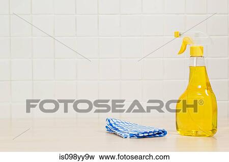 Bottle of yellow cleaning fluid and cleaning cloth View Large Photo Image Stock Photo - Bottle of yellow cleaning fluid and cleaning cloth. Fotosearch