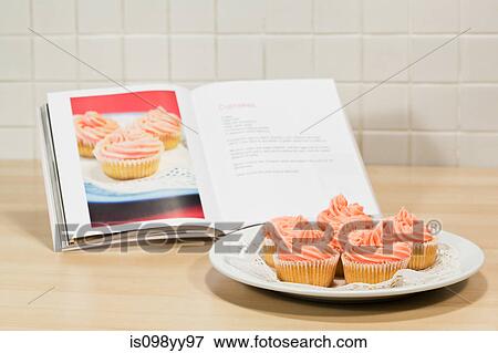 Cupcakes and cookery book View Large Photo Image Stock Photo - Cupcakes and cookery book. Fotosearch