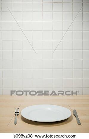 Stock Photo - Empty plate with knife and fork. Fotosearch