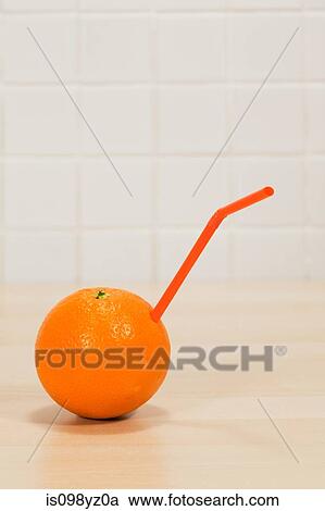 Orange with drinking straw sticking out View Large Photo Image Stock Image - Orange with drinking straw sticking out. Fotosearch