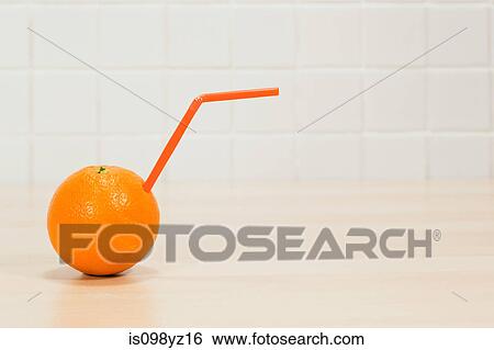 Orange with drinking straw sticking out View Large Photo Image Stock Photograph - Orange with drinking straw sticking out. Fotosearch