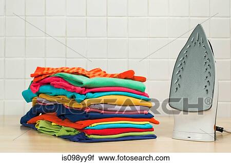 Piles of clean laundry and iron View Large Photo Image Stock Image - Piles of clean laundry and iron. Fotosearch