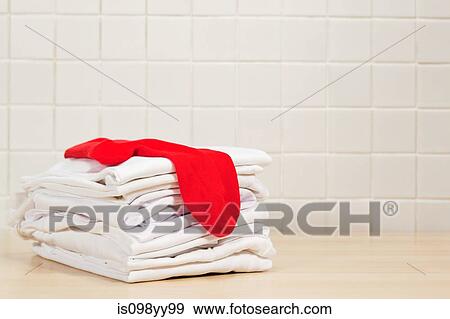 Piles of clean white laundry and red sock View Large Photo Image Stock Photo - Piles of clean white laundry and red sock. Fotosearch