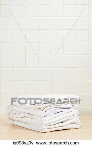 Piles of clean white laundry View Large Photo Image Stock Photo - Piles of clean white laundry. Fotosearch