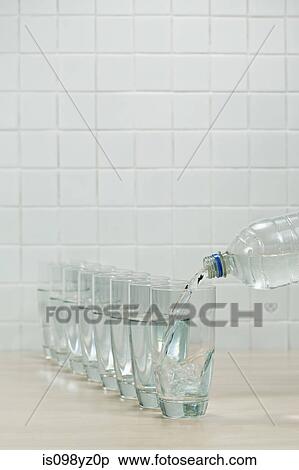 Pouring glasses of mineral water View Large Photo Image Stock Photography - Pouring glasses of mineral water. Fotosearch