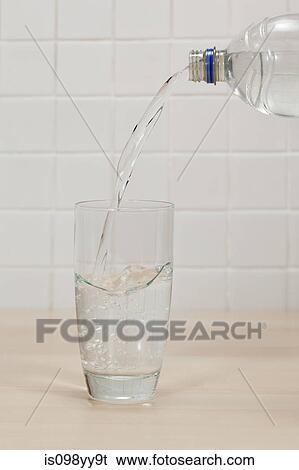 Pouring mineral water into glass View Large Photo Image Stock Photograph - Pouring mineral water into glass. Fotosearch