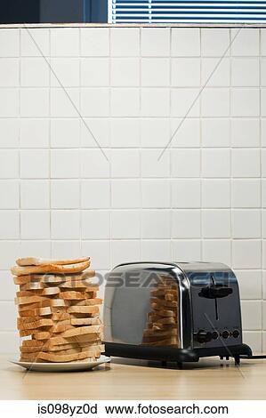 Stock Image - Stack of toast and toaster. Fotosearch