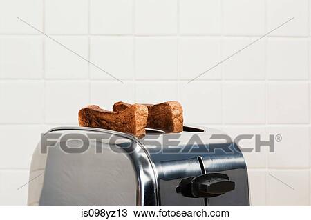 Two slices of toast in toaster View Large Photo Image Stock Image - Two slices of toast in toaster. Fotosearch