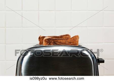 Two slices of toast in toaster View Large Photo Image Stock Photograph - Two slices of toast in toaster. Fotosearch