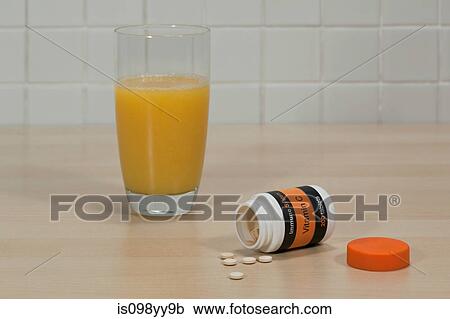 Vitamin c tablets and glass of orange juice View Large Photo Image Stock Image - Vitamin c tablets and glass of orange juice. Fotosearch