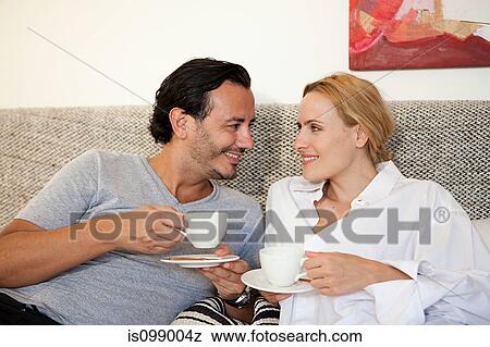 Couple having coffee in bed View Large Photo Image Stock Photo - Couple having coffee in bed. Fotosearch