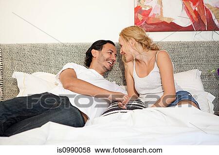 Couple on bed View Large Photo Image Stock Photo - Couple on bed. Fotosearch
