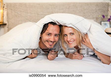 Couple under duvet View Large Photo Image Picture - Couple under duvet. Fotosearch