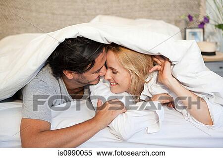 Couple under duvet View Large Photo Image Stock Photography - Couple under duvet. Fotosearch