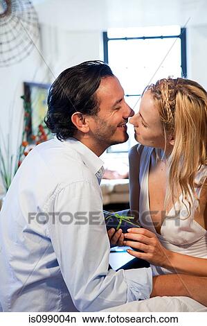 Loving couple with gift View Large Photo Image Picture - Loving couple with gift. Fotosearch