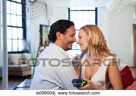 Loving couple with gift View Large Photo Image Stock Image - Loving couple with gift. Fotosearch