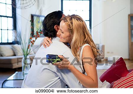 Loving couple with gift View Large Photo Image Stock Image - Loving couple with gift. Fotosearch