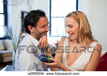 Man giving gift to wife View Large Photo Image Stock Image - Man giving gift to wife. Fotosearch