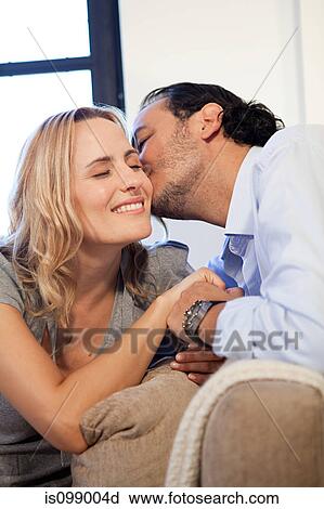 Man kissing wife on cheek View Large Photo Image Stock Image - Man kissing wife on cheek. Fotosearch