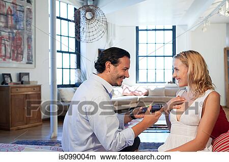 Man surprising wife with gift View Large Photo Image Picture - Man surprising wife with gift. Fotosearch