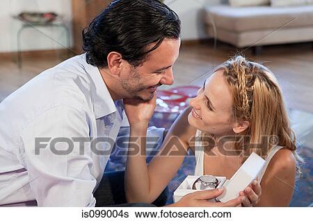 Woman giving gift of wrist watch to boyfriend View Large Photo Image Stock Photograph - Woman giving gift of wrist watch to boyfriend. Fotosearch