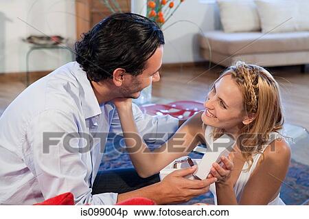 Woman giving gift of wrist watch to boyfriend View Large Photo Image Stock Photography - Woman giving gift of wrist watch to boyfriend. Fotosearch