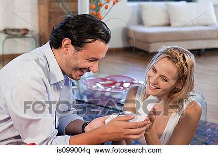 Woman giving gift of wrist watch to boyfriend View Large Photo Image Stock Photography - Woman giving gift of wrist watch to boyfriend. Fotosearch
